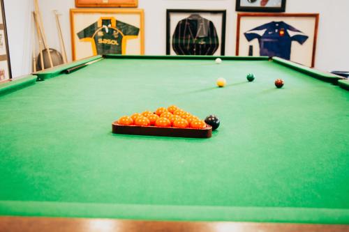 a pool table with a tray of balls on it at Laaiplek Hotel in Velddrif