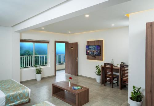a living room with a bed and a table at Green Tea Hotels in Devikolam