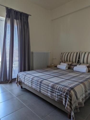 Ένα ή περισσότερα κρεβάτια σε δωμάτιο στο Samaras Apartments in Kamena Vourla