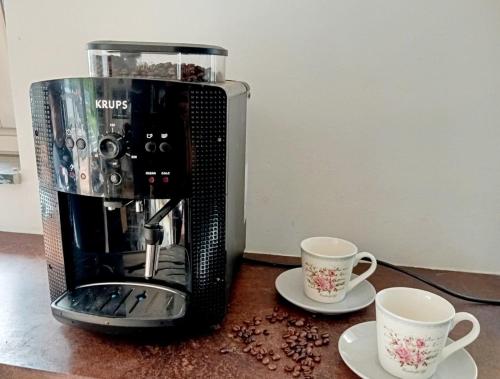a coffee maker and two cups on a counter at Luxury Villa Vienna in Mauerbach
