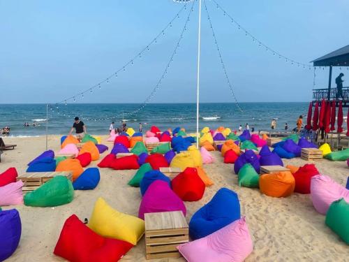 a group of colorful beach chairs on the beach at White's house in Quan Lạn