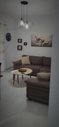 a living room with a couch and a coffee table at Eglent's tourist house in Sarandë