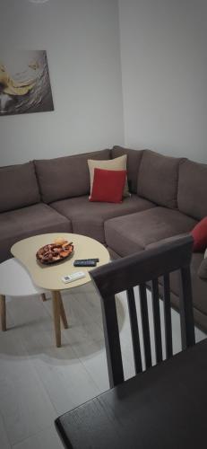 a living room with a couch and a coffee table at Eglent's tourist house in Sarandë