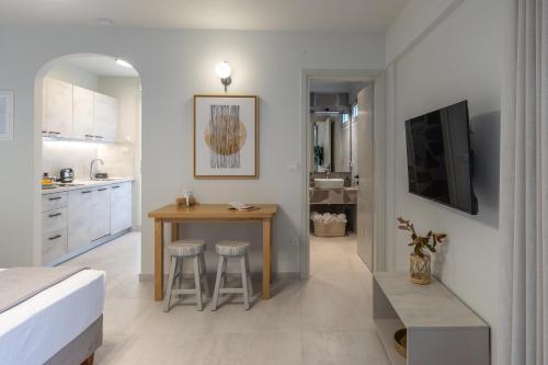 a kitchen and dining room with a table and a bed at One Bedroom Apartment Erato in Argostoli