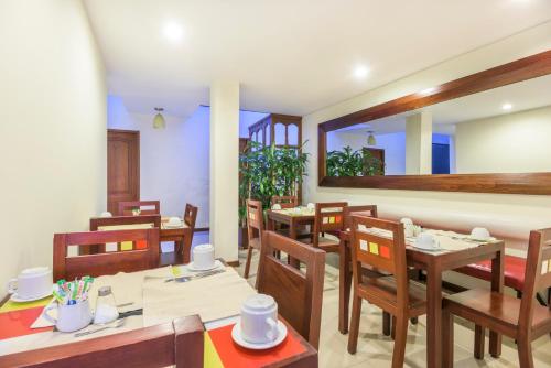 a dining room with wooden tables and chairs at Hotel Portofino in Bogotá