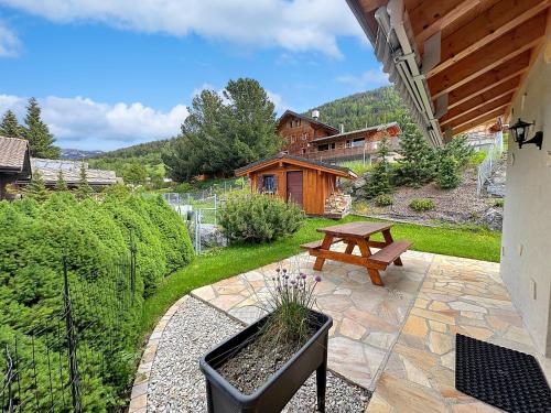 a patio with a bench and a picnic table at Chalet Etoile Polaire in Nendaz