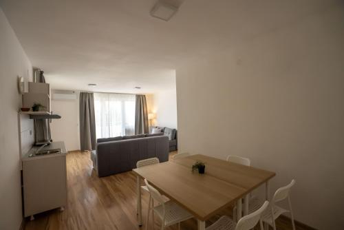 a living room with a table and a couch at Smeštaj Milutinn in Soko Banja