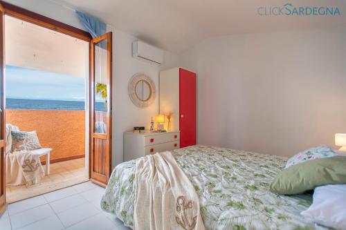 sypialnia z łóżkiem i widokiem na ocean w obiekcie Villa seashore of the Marina of Sorso, 3 rooms, veranda on the sea, garden w mieście Sorso