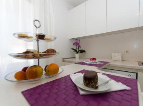 a kitchen with a plate of food on a counter at Apartments Villa Olea in Lumbarda