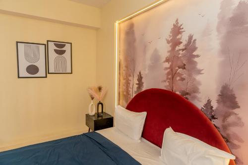 a bed with a red headboard in a room at Skystay Lucknow in Lucknow