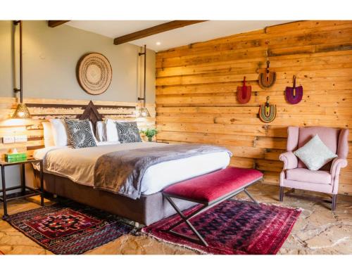a bedroom with a bed and a chair at Mua Hills Getaway in Katelembu