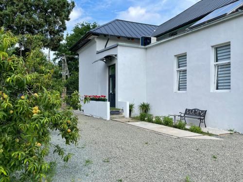 a white house with a bench in front of it at Wagner Villa 902 with free private parking in Budapest