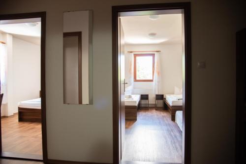 a door leading into a room with a bedroom at Penzion Pohádka in Hojsova Stráž
