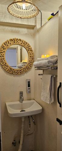 a bathroom with a sink and a mirror at The Boho House in Ujjain