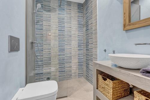 a bathroom with a shower and a toilet and a sink at Natura Oliva House in Alikanas