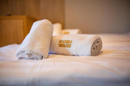 a roll of toilet paper sitting on a bed at Harem House in Mielno