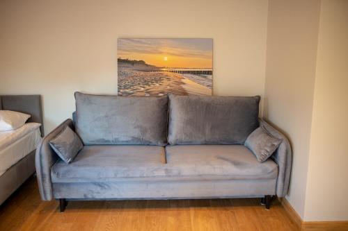 a couch in a room with a painting on the wall at Harem House in Mielno
