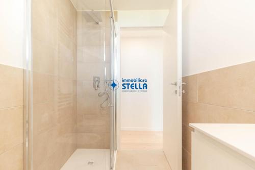 a shower with a glass door in a bathroom at Wave Island in Lido di Jesolo
