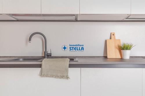 a kitchen sink with a sign on the wall at Wave Island in Lido di Jesolo