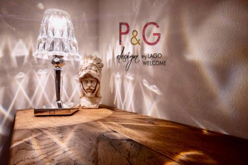 a table with a lamp and a skull on it at P&G design by Lago Welcome Enna in Enna