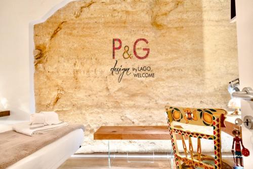 a room with a table and a chair and a wall at P&G design by Lago Welcome Enna in Enna