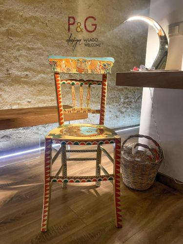 a colorful chair sitting in front of a counter at P&G design by Lago Welcome Enna in Enna