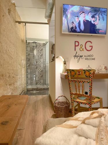 a bedroom with a bed and a tv on the wall at P&G design by Lago Welcome Enna in Enna