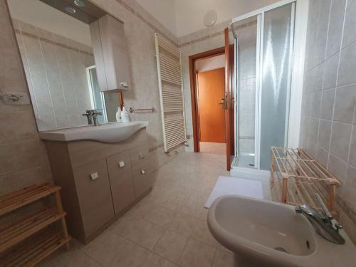 a bathroom with a sink and a toilet and a sink at Appartamento Ferrara nord in Ferrara