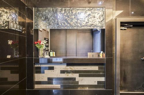 a bathroom with a counter with a mirror at TJ Hotel in Seoul