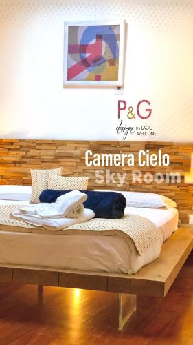 a bed in a room with a wooden frame at P&G design by Lago Welcome Enna in Enna