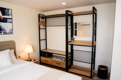 a room with a bed and a bunk bed at indigo Hotel Hatyai in Ban Kohong