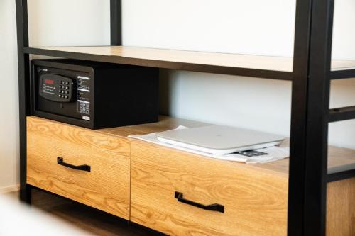 a microwave oven sitting on top of a wooden cabinet at indigo Hotel Hatyai in Ban Kohong