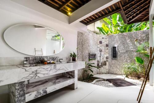 a bathroom with a sink and a mirror at Umani Village in Kerobokan