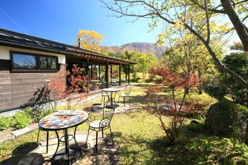 a group of tables and chairs in a yard at Spagreenness in Kokonoe