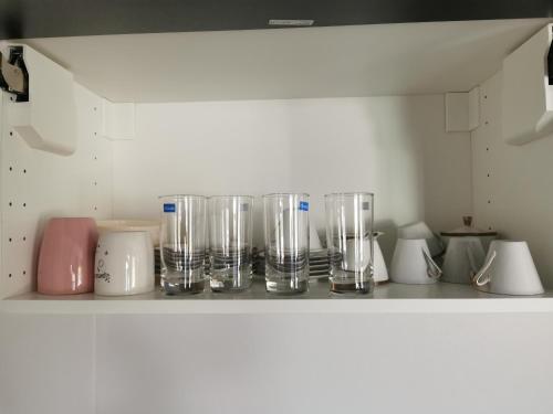 a shelf with many glass jars and other items at Pool Villa Mountainview in Cha Am