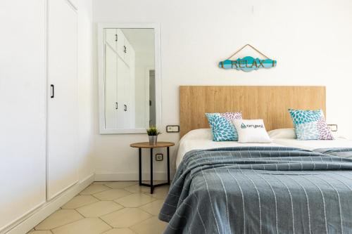 a bedroom with two beds and a mirror at NOVELTY III Arysal 3 in Salou