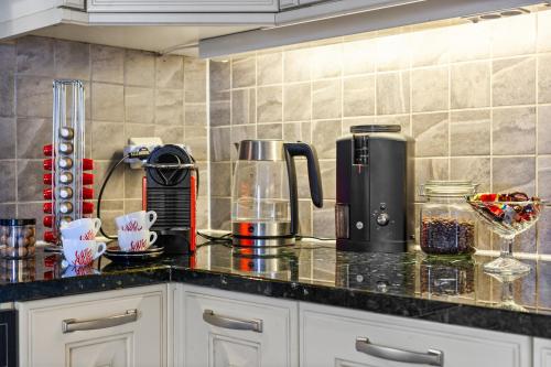 a kitchen with a counter top with a coffee maker at Klara in Sandefjord