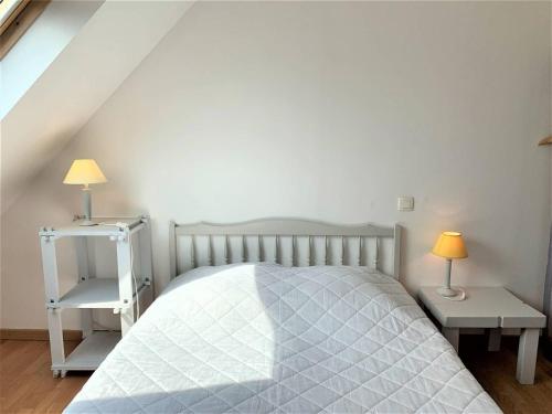 a bedroom with a white bed and two tables at Quiberon : maison 6 pers., 3 ch., jardin, quartier calme - FR-1-478-164 in Quiberon