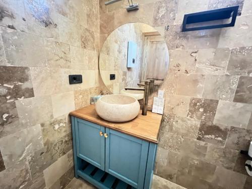 a bathroom with a sink and a mirror at Aden Garden Otel in Cesme