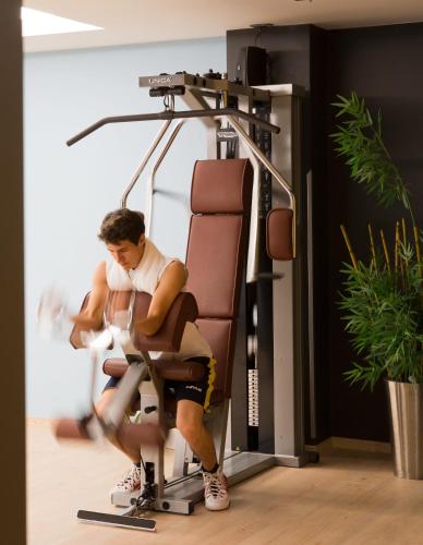 a man sitting in a chair in a salon at Best Western Plus Hotel Expo in Villafranca di Verona