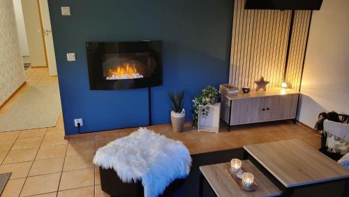 a living room with a couch and a fireplace at Cozy apartment in Alp House in Tahkovuori