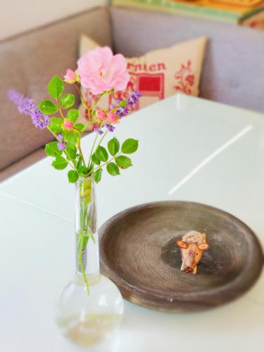 a vase with flowers in it on a table at Wellness- HotTub & Sauna- Pet Friendly- Hiking in Keutschach am See