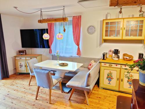 a kitchen and dining room with a table and chairs at Wellness- HotTub & Sauna- Pet Friendly- Hiking in Keutschach am See