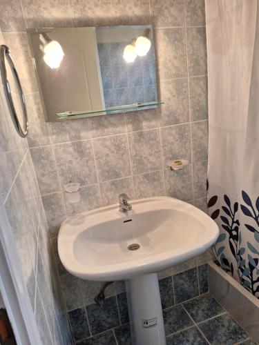 a bathroom with a sink and a mirror at Χαρά in Velimákhion