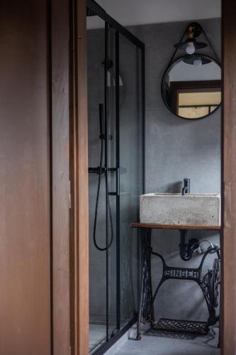 a bathroom with a sink and a mirror at Ötköb Cottage - Wine House in Miskolc