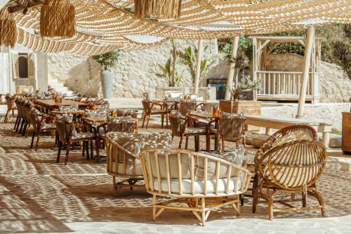 a restaurant with tables and chairs in a courtyard at Lords Palace Hotel SPA Casino in Kérynia