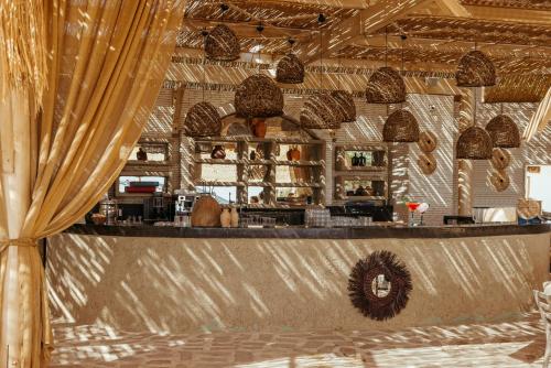 a bar in a restaurant with a curtain at Lords Palace Hotel SPA Casino in Kérynia