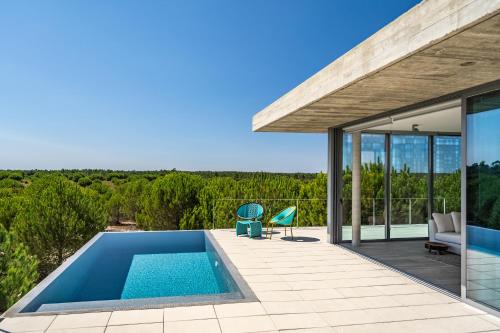 a swimming pool in the backyard of a house at Casas do Chaparral in Grândola
