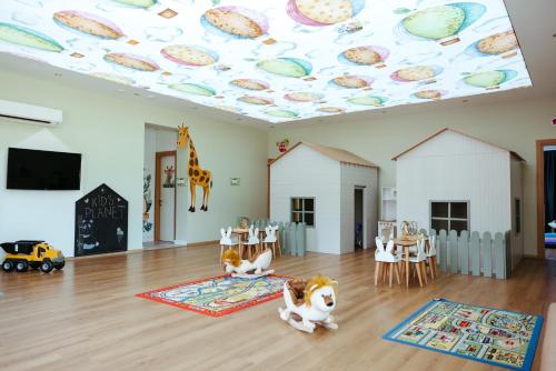 a room with a ceiling decorated with planets at Lords Palace Hotel SPA Casino in Kérynia