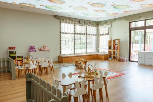 a room with tables and chairs and a room with a ceiling at Lords Palace Hotel SPA Casino in Kérynia